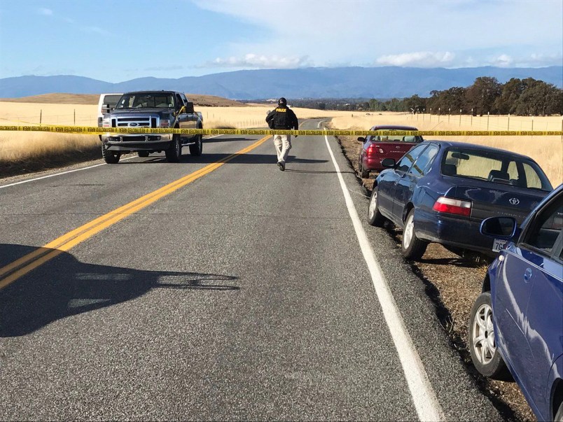 Crime tape blocks off Rancho Tehama Road leading into the Rancho Tehama subdivision about 20 miles south of Red Bluff, Calif., on Tuesday, Nov. 14, 2017. At least three people died and more were injured in a shooting.