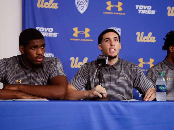 Flanked by teammates Cody Riley, left, and Jalen Hill, UCLA basketball player LiAngelo Ball reads his statement during a news conference at UCLA Wednesday, Nov. 15, 2017, in Los Angeles. The three players were detained in Hangzhou following allegations of shoplifting last week before a game against Georgia Tech in Shanghai. (AP Photo/Jae C. Hong)