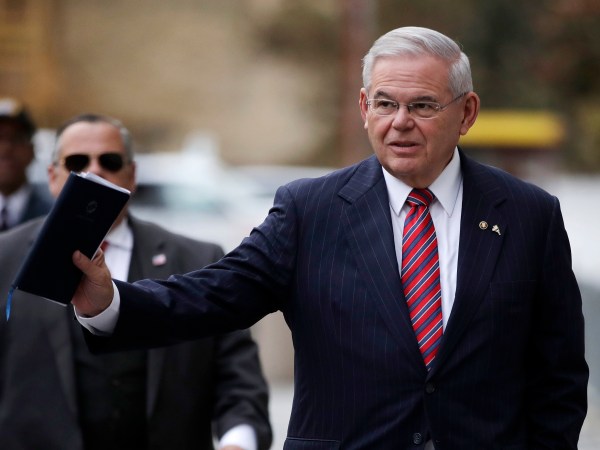 U.S. Sen. Bob Menendez waves at reporters before entering the Martin Luther King Jr. Federal Courthouse for his federal corruption trial, Thursday, Nov. 16, 2017, in Newark, N.J. Jury deliberations continued on Thursday morning. (AP Photo/Julio Cortez)