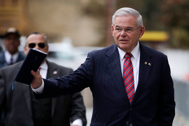 U.S. Sen. Bob Menendez waves at reporters before entering the Martin Luther King Jr. Federal Courthouse for his federal corruption trial, Thursday, Nov. 16, 2017, in Newark, N.J. Jury deliberations continued on Thursday morning. (AP Photo/Julio Cortez)