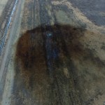 This aerial photo shows spills from TransCanada Corp.'s Keystone pipeline, Friday, Nov. 17, 2017, that leaked an estimated 210,000 gallons of oil onto agricultural land in northeastern South Dakota, near Amherst, S.D., the company and state regulators said Thursday, but state officials don't believe the leak polluted any surface water bodies or drinking water systems. Crews shut down the pipeline Thursday morning and activated emergency response procedures after a drop in pressure was detected resulting from the leak south of a pump station in Marshall County, TransCanada said in a statement. The cause was being investigated. (DroneBase via AP)