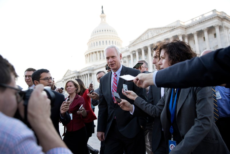 Sen. Ron Johnson, R-Wis., is surrounded by media as he walks from the Capitol building on Capitol Hill in Washington, Wednesday, Nov. 29, 2017. (AP Photo/Carolyn Kaster)