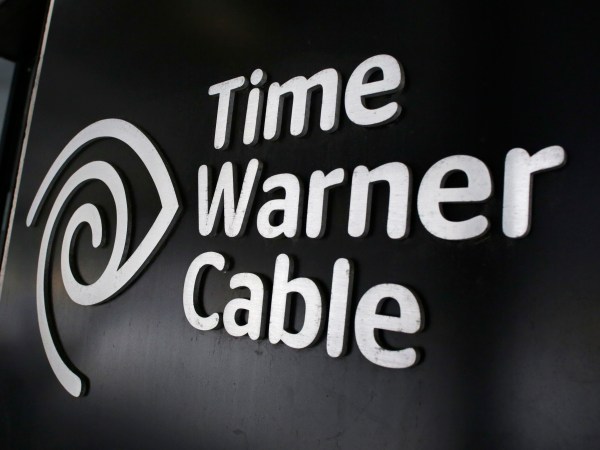 FILE - In this May 26, 2015, file photo, the Time Warner Cable corporate logo is displayed at a company store, in New York. On Monday, April 25, 2016, the Justice Department approved Charter’s bid to buy Time Warner Cable and create another cable giant. Monday’s OK comes with conditions meant to preserve competition from online services. Additional approvals are required, but expected, before the deal closes. (AP Photo/Mark Lennihan, File)