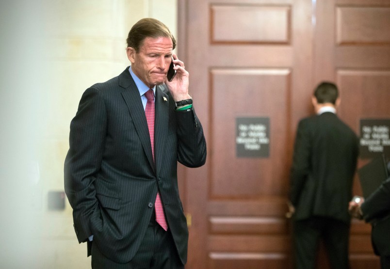 Sen. Richard Blumenthal, D-Conn., a member of the Senate Judiciary Committee, makes a phone call as Donald Trump Jr., interviewed behind closed doors by committee staff investigating the meddling and possible Russian links to President Donald Trump's 2016 presidential campaign, at the Capitol in Washington, Thursday, Sept. 7, 2017. Trump Jr. released a series of emails in July that detailed preparations for a June 2016 meeting with a Russian lawyer and others where he was expecting to get damaging information about Democratic candidate Hillary Clinton.   (AP Photo/J. Scott Applewhite)