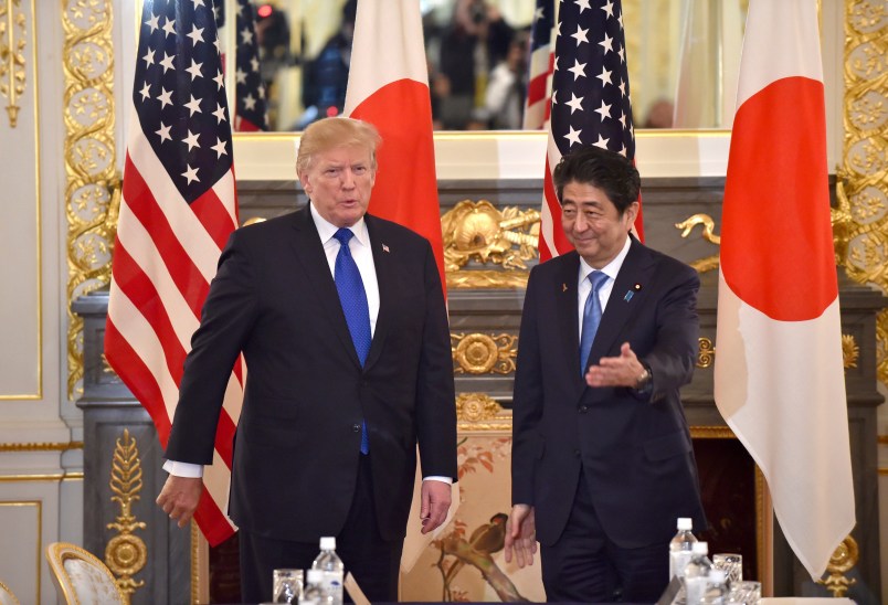 US President Donald Trump (L) is led by Japanese Prime Minister Shinzo Abe (R) before a summit meeting at Akasaka Palace in Tokyo on November 6, 2017. / AFP PHOTO / POOL / Kazuhiro NOGI /// Attn photo desk (AFP POOL-Trump/Abe summit meeting-7) Herewith AFP POOL photo, 110607F. 110607F: US President Donald Trump (L ) is led by Japanese Prime Minister Shinzo Abe (R ) before a summit meeting at Akasaka Guest House in Tokyo on November 6, 2017. AFP PHOTO / POOL / Kazuhiro NOGICheers, Nogi/tokpix