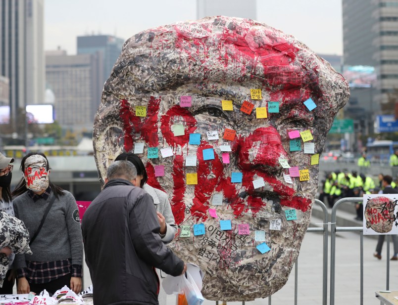 A huge mask of U.S. President Donald Trump is displayed with letters "No War" near the venue for anti-war rally in Seoul, South Korea, Tuesday, Nov. 7, 2017. South Korean police were on high alert in Seoul on Tuesday to monitor protests by both critics and supporters of President Donald Trump as the U.S. leader arrived in the country amid concerns over North Korea's nuclear threats. (AP Photo/Lee Jin-man)