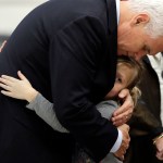 Vice President Mike Pence hugs Evelyn Holcombe at Florseville High School during a stop, Wednesday, Nov. 8, 2017, in Floresville, Texas.  A man opened fire inside the church in the small South Texas community on Sunday, killing and wounding many; Hiolcombe was in the church during the shooting but escaped. (AP Photo/Eric Gay)