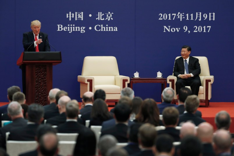 U.S. President Donald Trump speaks next to Chinese President Xi Jinping on stage during a business event at the Great Hall of the People in Beijing, Thursday, Nov. 9, 2017. Trump is on a five-country trip through Asia traveling to Japan, South Korea, China, Vietnam and the Philippines. (AP Photo/Andy Wong)