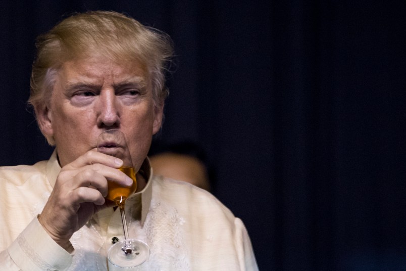 President Donald Trump takes a drink following a toast by Philippines President Rodrigo Duterte at an ASEAN Summit dinner at the SMX Convention Center, Sunday, Nov. 12, 2017, in Manila, Philippines. Trump is on a five country trip through Asia traveling to Japan, South Korea, China, Vietnam and the Philippines. (AP Photo/Andrew Harnik)