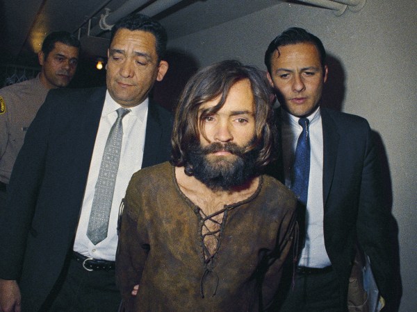 FILE - In this 1969 file photo, Charles Manson is escorted to his arraignment on conspiracy-murder charges in connection with the Sharon Tate murder case. (AP Photo/File)