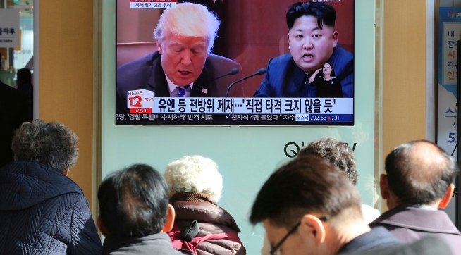 FILE- In this Tuesday, Nov. 21, 2017, file photo, people watch a TV screen showing images of U.S. President Donald Trump, left, and North Korean leader Kim Jong Un at Seoul Railway Station in Seoul, South Korea. North Korea has called on Wednesday, Nov. 22, 2017,Trump's decision to relist the country as a state sponsor of terrorism a "serious provocation" that justifies its development of nuclear weapons. The signs read "UN sanctions and The blow is not big." (AP Photo/Ahn Young-joon, File)