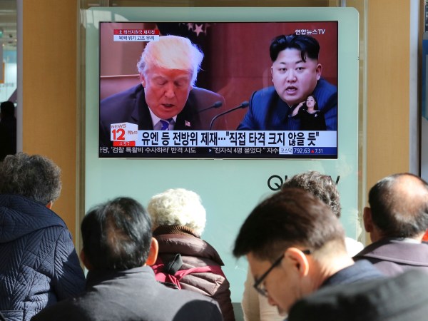 FILE- In this Tuesday, Nov. 21, 2017, file photo, people watch a TV screen showing images of U.S. President Donald Trump, left, and North Korean leader Kim Jong Un at Seoul Railway Station in Seoul, South Korea. North Korea has called on Wednesday, Nov. 22, 2017,Trump's decision to relist the country as a state sponsor of terrorism a "serious provocation" that justifies its development of nuclear weapons. The signs read "UN sanctions and The blow is not big." (AP Photo/Ahn Young-joon, File)