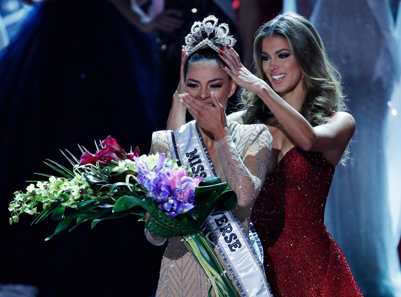 Formers Miss Universe Iris Mittenaere, right, crowns new Miss Universe Demi-Leigh Nel-Peters at the Miss Universe pageant Sunday, Nov. 26, 2017, in Las Vegas. (AP Photo/John Locher)