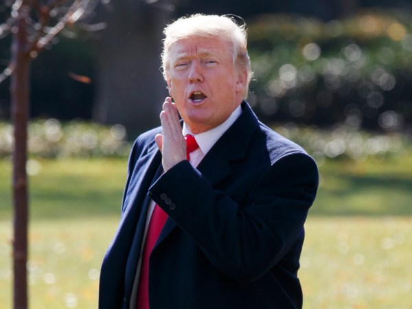 President Donald Trump yells to reporters as he walks to board Marine One on the South Lawn of the White House, Wednesday, Nov. 29, 2017, in Washington. (AP Photo/Evan Vucci)