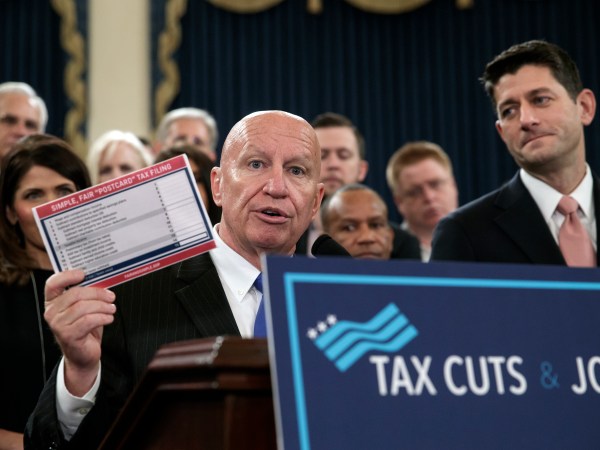 House Ways and Means Committee Chairman Kevin Brady, R-Texas, joined by Speaker of the House Paul Ryan, R-Wis., right, holds a proposed "postcard tax filing form" as they unveil the GOP's far-reaching tax overhaul, the first major revamp of the tax system in three decades, on Capitol Hill in Washington, Thursday, Nov. 2, 2017.  (AP Photo/J. Scott Applewhite)