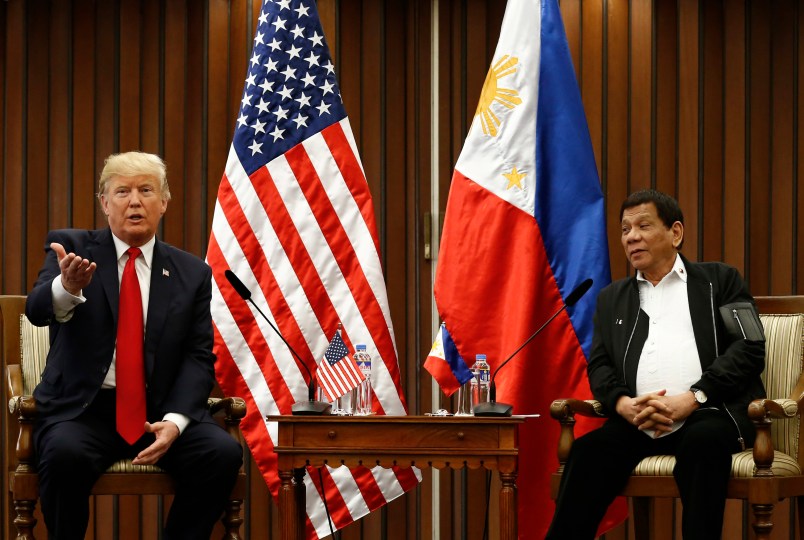 U.S. President Donald J. Trump, left, gestures beside Philippine President Rodrigo Duterte as they hold a bilateral meeting on the sidelines of the 31st Association of Southeast Asian Nations (ASEAN) Summit and Related Meetings at the Philippine International Convention Center in Manila, Philippines on Monday November 13, 2017. (Rolex dela Pena/Pool Photo via AP)