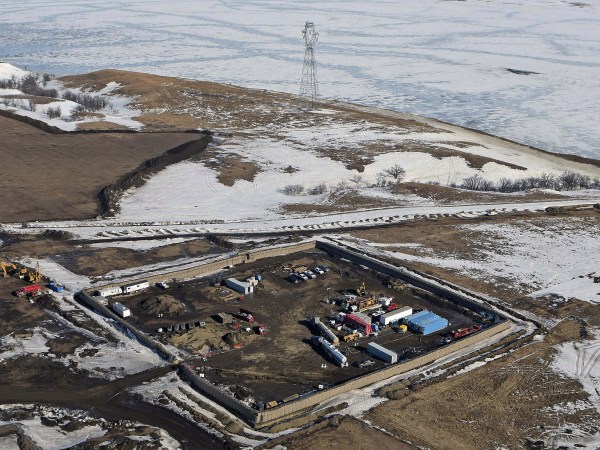FILE - This Feb. 13, 2017, aerial file photo shows a site where the final phase of the Dakota Access Pipeline near the Missouri River took place with boring equipment routing the pipeline underground and across Lake Oahe to connect with the existing pipeline in Emmons County in Cannon Ball, N.D. A federal judge on Monday, Dec. 4, 2017, ordered the Army Corps of Engineers and pipeline developer Energy Transer Partners to complete an oil spill response plan for a section of the pipeline beneath the Missouri River in North Dakota. (Tom Stromme/The Bismarck Tribune via AP, File)