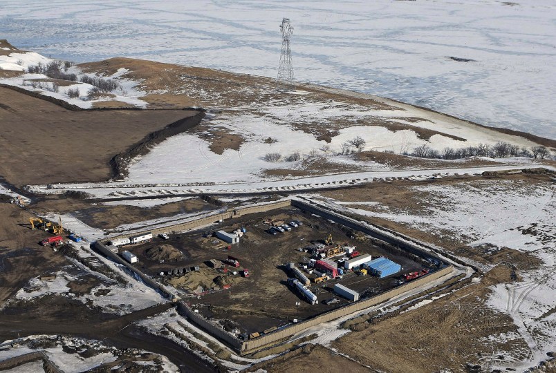 FILE - This Feb. 13, 2017, aerial file photo shows a site where the final phase of the Dakota Access Pipeline near the Missouri River took place with boring equipment routing the pipeline underground and across Lake Oahe to connect with the existing pipeline in Emmons County in Cannon Ball, N.D. A federal judge on Monday, Dec. 4, 2017, ordered the Army Corps of Engineers and pipeline developer Energy Transer Partners to complete an oil spill response plan for a section of the pipeline beneath the Missouri River in North Dakota. (Tom Stromme/The Bismarck Tribune via AP, File)