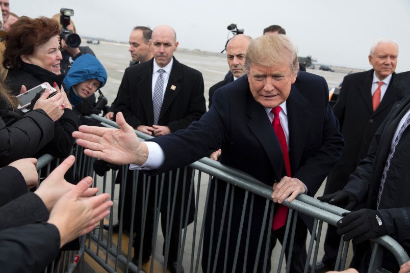 President Donald Trump shakes hands with supporters after arriving at Salt Lake City International Airport, Monday, Dec. 4, 2017, in Salt Lake City. (AP Photo/Evan Vucci)