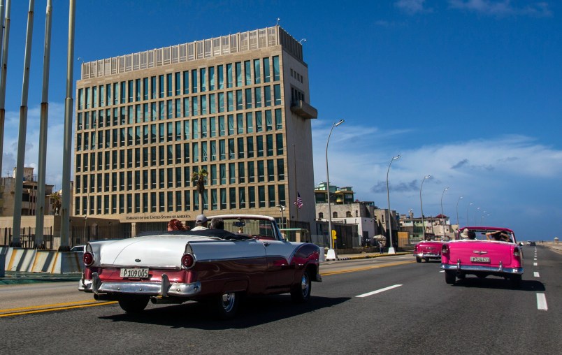 Tourists ride classic convertible cars on the Malecon beside the United States Embassy in Havana, Cuba, Tuesday, Oct. 3, 2017. Thousands of private Cuban businesses have invested heavily in private homes, cars and restaurants, hoping to cash in on an expected wave of American travelers to the island. Now that the U.S. State Department has issued a travel warning for the country, their investments are at risk.(AP Photo/Desmond Boylan)