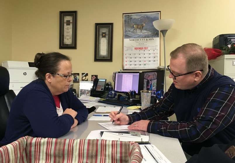 /// CAPTIONDavid Ermold files to run for Rowan County Clerk in Kentucky as Clerk Kim Davis look on in Morehead, Kentucky, on Wednesday, Dec. 6, 2017. Davis denied Ermold and his husband a marriage license two years ago because she was opposed to gay marriage for religious reasons.Photo taken by Adam Beam