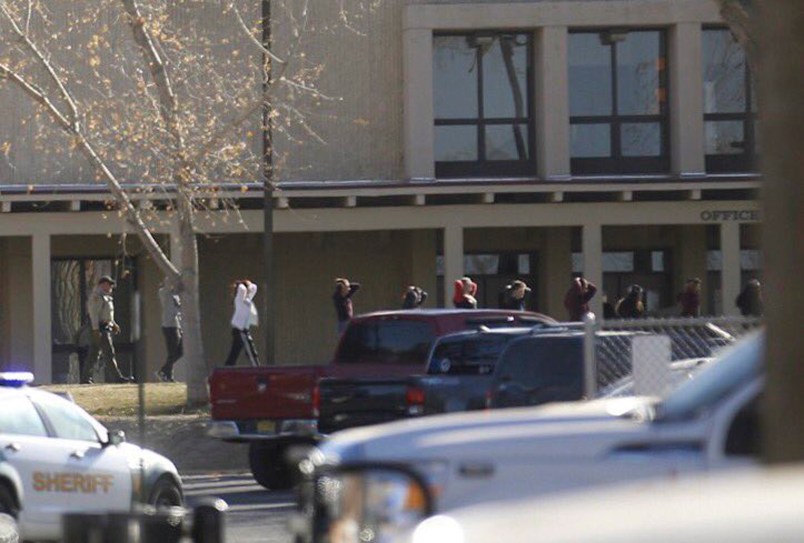 Students are led out of Aztec High School after a shooting Thursday, Dec. 7, 2017, in Aztec, N.M. Authorities say three people dead. The school is in the Four Corners region and is near the Navajo Nation.(Jon Austria/The Daily Times via AP)