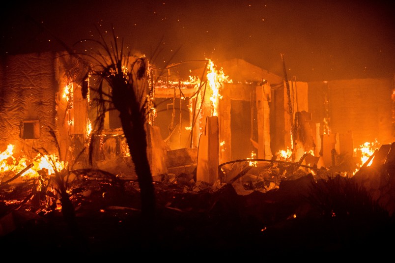 Flames consume a structure as the Lilac fire burns in Bonsai, Calif., on Friday, Dec. 8, 2017. The blaze burned at least five structures and 4,100 acres according to fire officials. Wind-swept blazes have forced tens of thousands of evacuations and destroyed dozens of homes in Southern California. (AP Photo/Noah Berger)