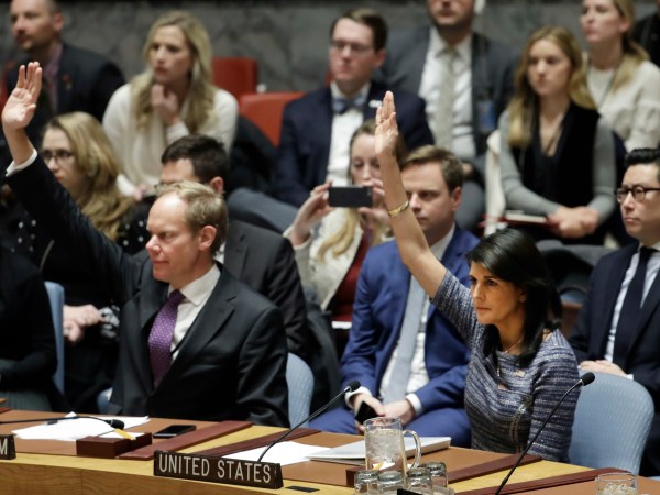 Matthew Rycroft, left, Britain's ambassador to the U.N. and U.S. Ambassador Nikki Haley vote in favor of a resolution, Friday, Dec. 22, 2017, at United Nations headquarters. The council is voting on proposed new sanctions against North Korea, including sharply lower limits on its refined oil imports, the return home of all North Koreans working overseas within 12 months, and a crackdown on the country's shipping. (AP Photo/Mark Lennihan)