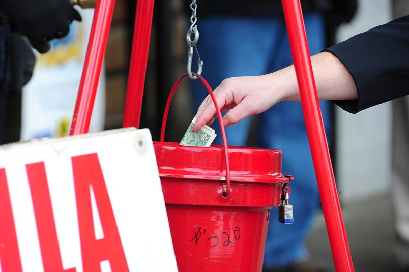 A patron donates money as the The Salvation Army of Wilkes-Barre celebrated its season of generosity with its annual Red Kettle Kick-Off, Wednesday, November 22, at Schiel’s Market on Hanover Street in Wilkes-Barre, Pa., The iconic tradition of bell ringers and red kettles is the most recognizable fundraising effort for The Salvation Army. Mark Morancv23salvationp1PAWIC101