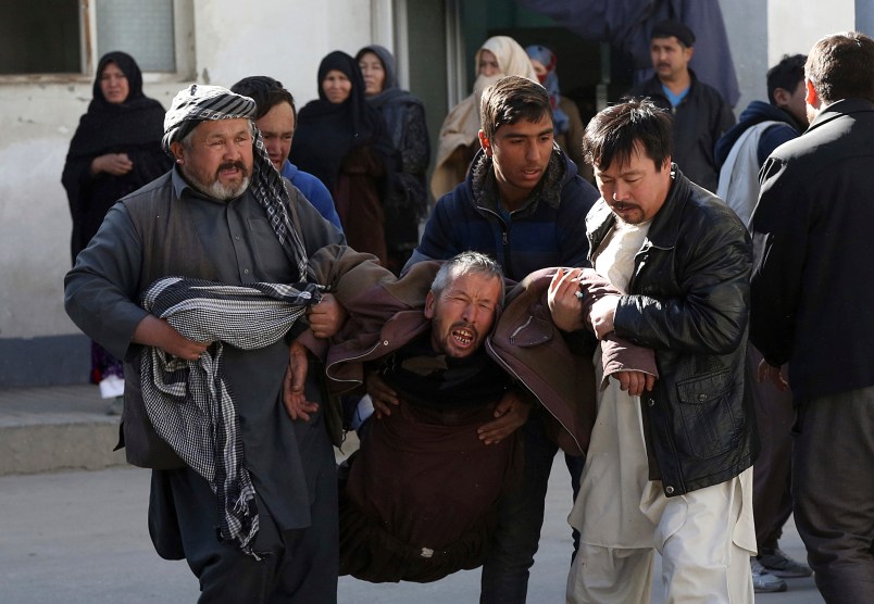 An Afghan man, center, cry after after a suicide attack in Kabul, Afghanistan, Thursday, Dec. 28, 2017. Authorities say two simultaneous attacks, including a suicide bombing attack, in Afghanistan’s capital have left at least 35 dead and 20 wounded. (AP Photo/Rahmat Gul)