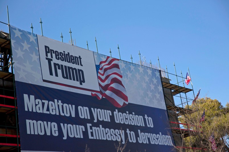 A sign hangs on a building under construction in Jerusalem congratulating U.S. President Donald Trump, Friday, Jan. 20, 2017. Trump has vowed to move the U.S. embassy from Tel Aviv to more controversial Jerusalem. (AP Photo/Ariel Schalit)