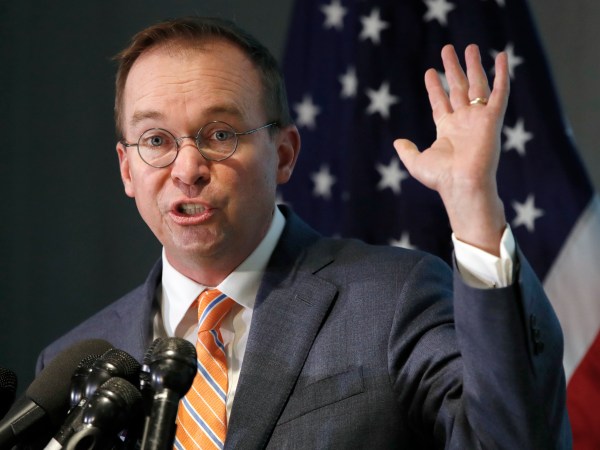 Mick Mulvaney holds up his hand as he speaks during a news conference after his first day as acting director of the Consumer Financial Protection Bureau in Washington, Monday, Nov. 27, 2017. (AP Photo/Jacquelyn Martin)
