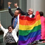 Members of parliament Cathy McGowan, Adam Brandt and Andrew Wilkie celebrate the passing of the Marriage Amendment Bill in the House of Representatives at Parliament House in Canberra, Thursday, Dec. 7, 2017. Gay marriage was endorsed by 62 percent of Australian voters who responded to a government-commissioned postal ballot by last month. (Mick Tsikas/AAP Image via AP)