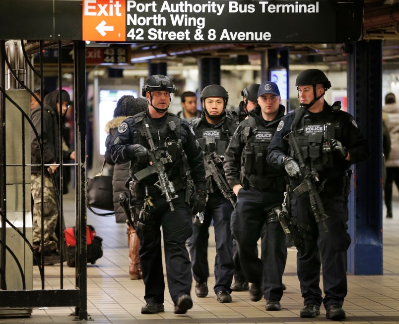 Heavily armed police officers patrol near the site of a terror attack in the subways under Port Authority Bus Terminal in New York, Tuesday, Dec. 12, 2017. A would-be suicide bomber's rush-hour blast in the heart of the New York City subway system failed to cause the bloodshed he intended, authorities said, but it gave new fuel to President Donald Trump's push to limit immigration. (AP Photo/Seth Wenig)
