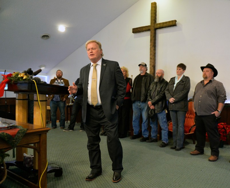 With friends and family standing behind him, Kentucky State Rep., Republican Dan Johnson addresses the public from his church on Tuesday, Dec. 12, 2017, regarding allegations that he sexually abused a teenager after a New Year's party in 2013, in Louisville, Ky. Johnson says a woman’s claim that he sexually assaulted her in 2013 has no merit and he will not resign. (AP Photo/Timothy D. Easley)