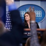 White House press secretary Sarah Huckabee Sanders listens to a reporter's question as other raise their hands to ask a question, during a press briefing at the White House, Tuesday, Dec. 12, 2017, in Washington. (AP Photo/Alex Brandon)