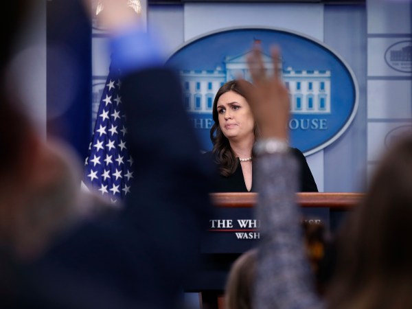 White House press secretary Sarah Huckabee Sanders listens to a reporter's question as other raise their hands to ask a question, during a press briefing at the White House, Tuesday, Dec. 12, 2017, in Washington. (AP Photo/Alex Brandon)