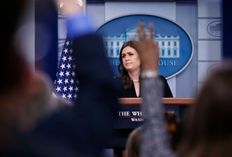 White House press secretary Sarah Huckabee Sanders listens to a reporter's question as other raise their hands to ask a question, during a press briefing at the White House, Tuesday, Dec. 12, 2017, in Washington. (AP Photo/Alex Brandon)