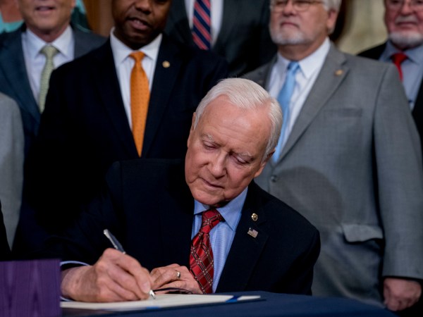 Senate Finance Committee Chairman Orrin Hatch, R-Utah, signs the final version of the GOP tax bill during an enrollment ceremony at the Capitol in Washington, Thursday, Dec. 21, 2017. (AP Photo/Andrew Harnik)