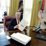 President Donald Trump talks with reporters before boarding Marine One on the South Lawn of the White House, Friday, Dec. 22, 2017, in Washington. (AP Photo/Evan Vucci)
