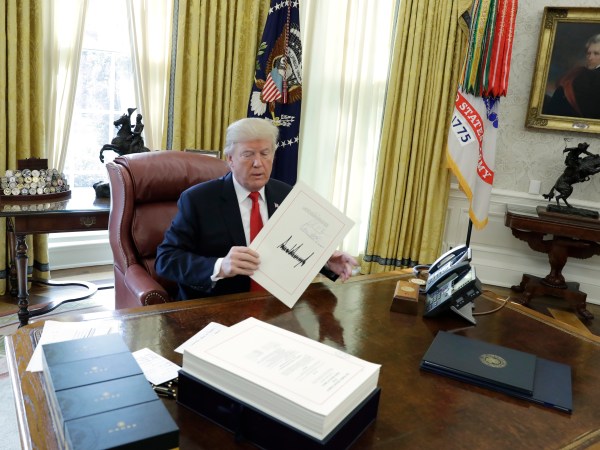 President Donald Trump talks with reporters before boarding Marine One on the South Lawn of the White House, Friday, Dec. 22, 2017, in Washington. (AP Photo/Evan Vucci)