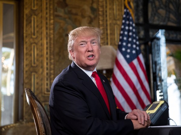 President Donald Trump turns to talk to the gathered media during a Christmas Eve video teleconference with members of the mIlitary at his Mar-a-Lago estate in Palm Beach, Fla., Sunday, Dec. 24, 2017. (AP Photo/Carolyn Kaster)