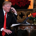 President Donald Trump speaks on the phone with children as they track Santa's movements with the North American Aerospace Defense Command (NORAD)  Santa Tracker on Christmas Eve at the president's Mar-a-Lago estate in Palm Beach, Fla., Sunday, Dec. 24, 2017. (AP Photo/Carolyn Kaster)