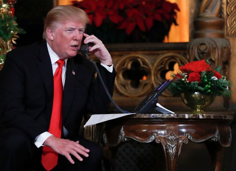 President Donald Trump speaks on the phone with children as they track Santa's movements with the North American Aerospace Defense Command (NORAD)  Santa Tracker on Christmas Eve at the president's Mar-a-Lago estate in Palm Beach, Fla., Sunday, Dec. 24, 2017. (AP Photo/Carolyn Kaster)