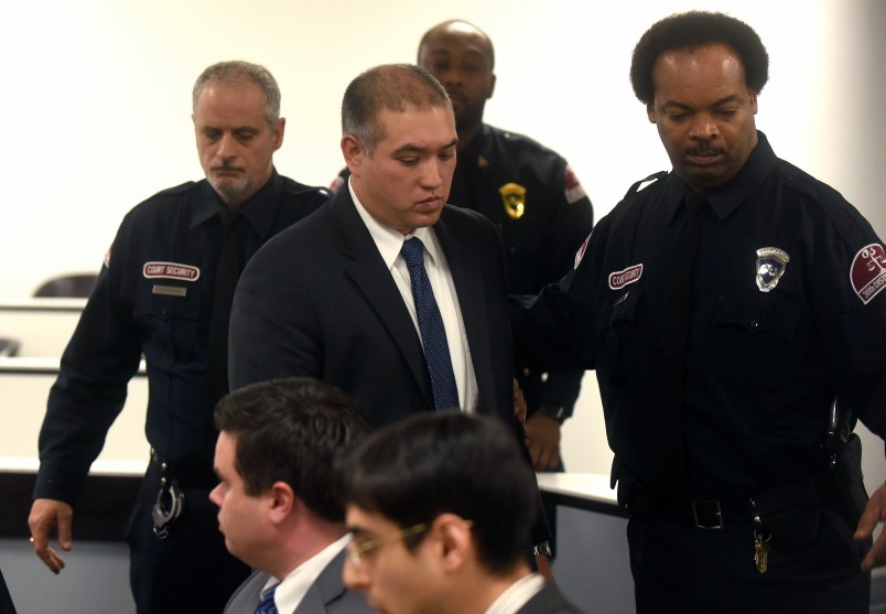 FILE - in this Dec. 21, 2017 file photo, former Michigan State Trooper Mark Bessner, center, arrives at his arraignment in 36th District Court in Detroit. Bessner is charged with murder in the death of Damon Grimes after he fired a Taser at the teenager who crashed an all-terrain vehicle and died. Bessner is charged with murder in the death of Grimes, but it wasn’t his only incident involving a Taser. State police wanted to suspend Bessner for 10 days for firing his Taser twice at a handcuffed man who was running away in 2016. He was also questioned in a separate 2014 taser incident. (Max Ortiz/Detroit News via AP File)