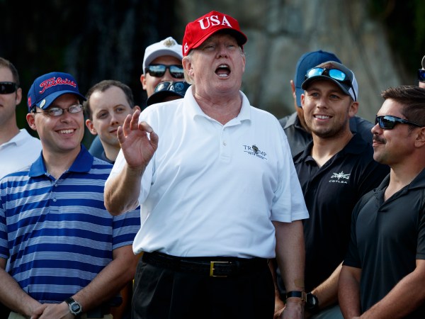 President Donald Trump speaks as he meets with members of the Coast Guard who he invited to play golf at Trump International Golf Club, Friday, Dec. 29, 2017, in West Palm Beach, Fla. (AP Photo/Evan Vucci)