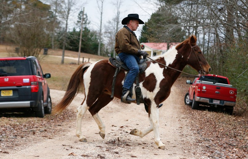 U.S. Senate candidate Roy Moore rides a horse to vote during the Alabama senatorial election, Tuesday, Dec. 12, 2017, in Gallant, Ala. (AP Photo/Brynn Anderson)