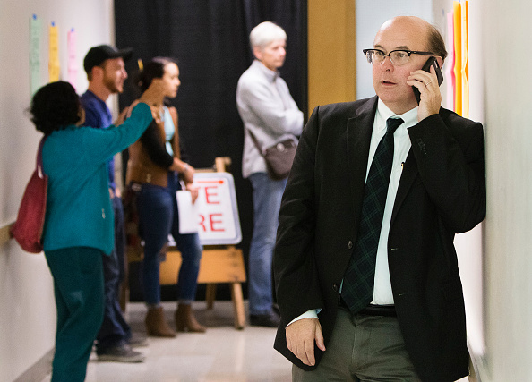 PORTLAND, ME - NOVEMBER 8: Maine Secretary of State Matthew Dunlap fields a phone call during one of several election day stops, to see how the polling process is going, at the Merrill Auditorioun Rehearsal Hall voting location in Portland on Tuesday, November 8, 2016. (Photo by Carl D. Walsh/Staff Photographer)