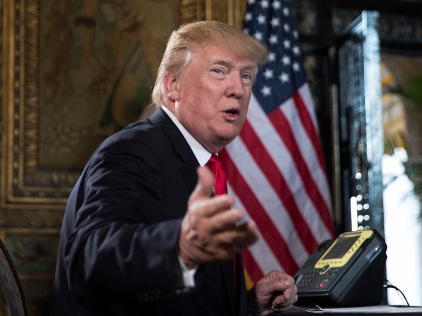 President Donald Trump turns to talk to the gathered media during a Christmas Eve video teleconference with members of the mIlitary at his Mar-a-Lago estate in Palm Beach, Fla., Sunday, Dec. 24, 2017. (AP Photo/Carolyn Kaster)
