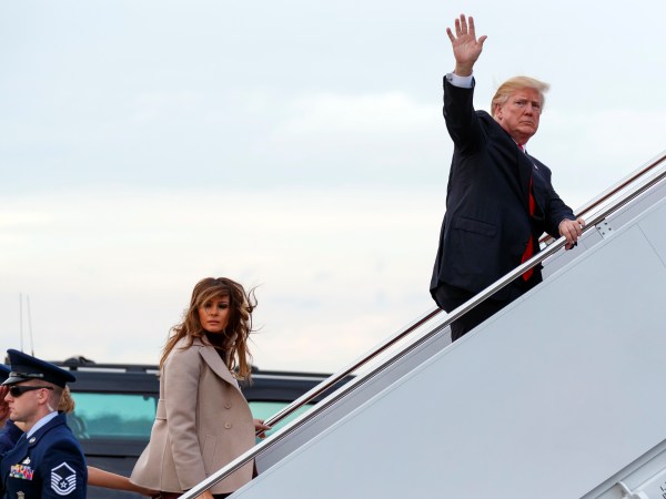 President Donald Trump and first lady Melania Trump board Air Force One at Palm Beach International Airport, Monday, Jan. 1, 2018, in West Palm Beach, Fla. (AP Photo/Evan Vucci)